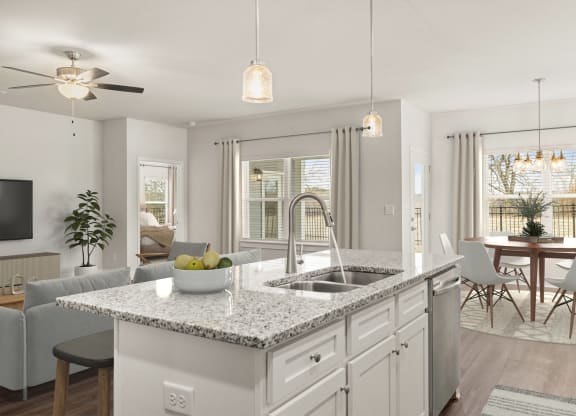 an open kitchen and living room with an island and a sink