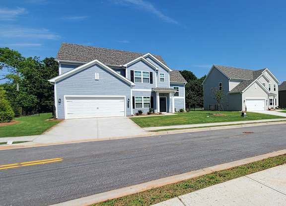 A row of houses with a clear blue sky above them.