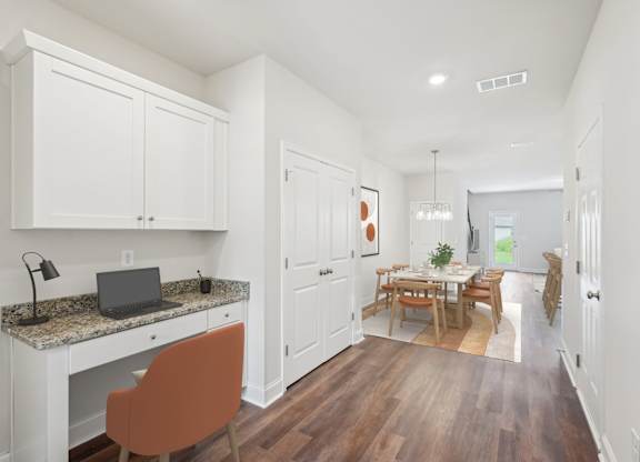 The entrance to the Monterey home featuring rich hardwood-style flooring and crisp white walls.
