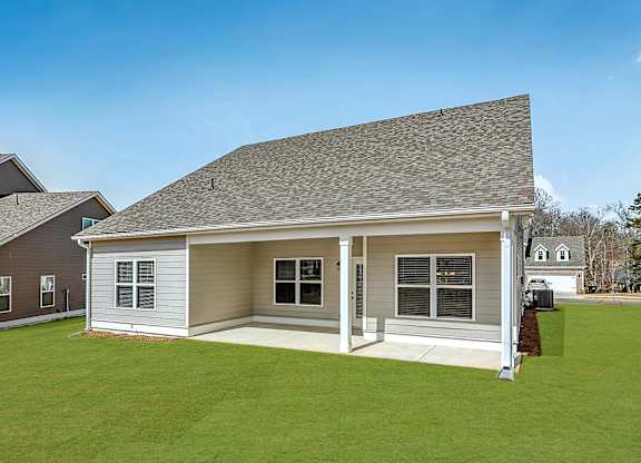 A house with a grey roof and a brown door.