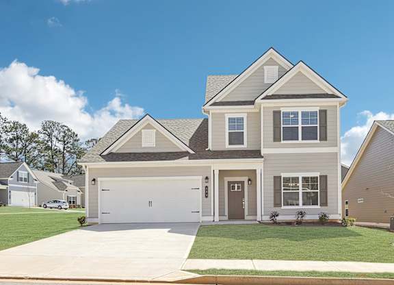 A two-story house with a garage is shown in the image.