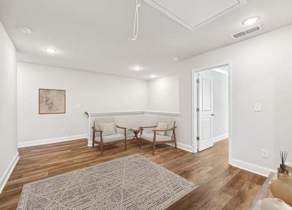Cozy upstairs loft featuring two stylish chairs—perfect for relaxing or unwinding with a good book.