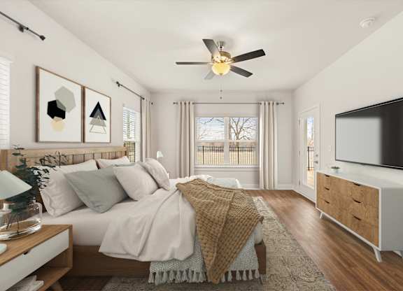 A bedroom with a bed, a ceiling fan, and a television.