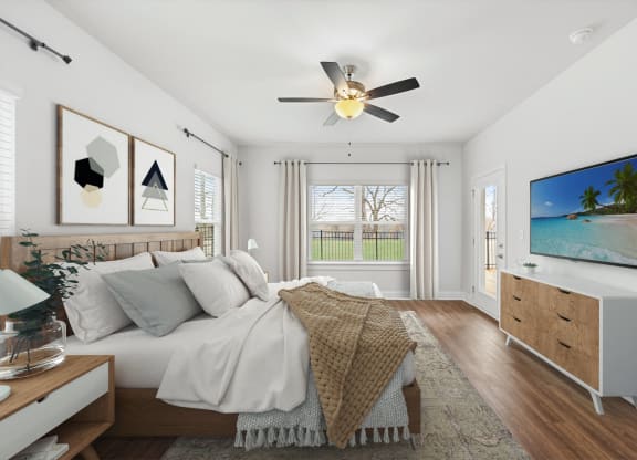 a bedroom with a large bed and a ceiling fan