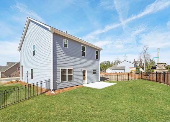 A house with a grey siding and a black fence.