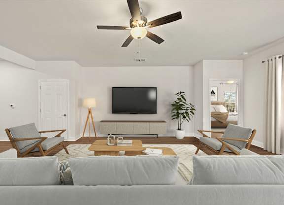 A living room with a grey couch and a wooden coffee table.