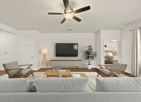 a living room with a couch and a ceiling fan