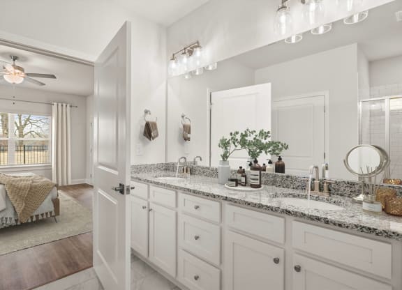 a bathroom with white cabinets and a sink and a mirror