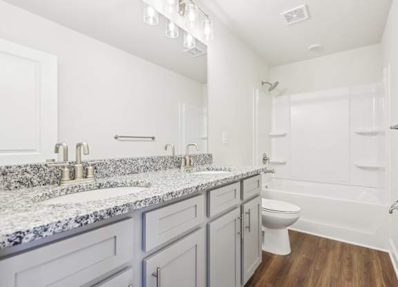 A bathroom with a toilet, sink, and bathtub.
