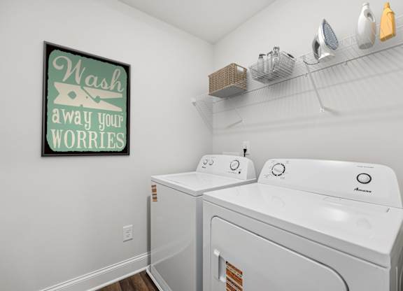 A spacious laundry room complete with full-size washer and dryer.