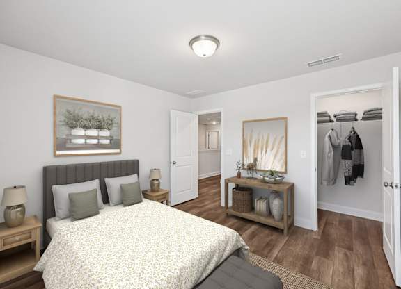 A view of the secondary suite with a large bed and a wooden nightstand.