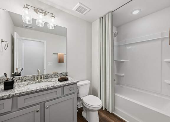 Secondary suite bathroom with a tub and shower combination