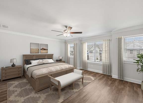 The elegant primary bedroom featuring a plush bed, stylish nightstand, and accent chair.