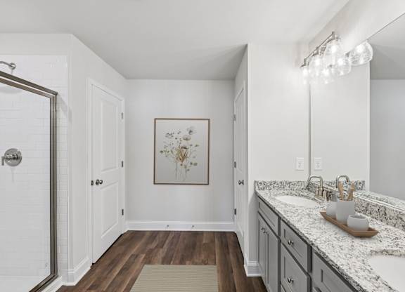 A luxurious primary bathroom with a double vanity and spacious walk-in shower.