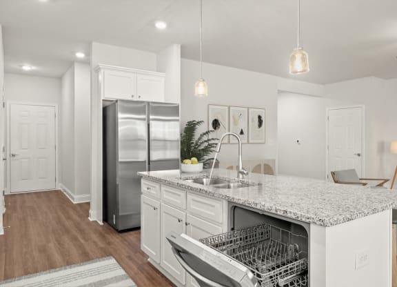 a kitchen with a island and a stainless steel refrigerator