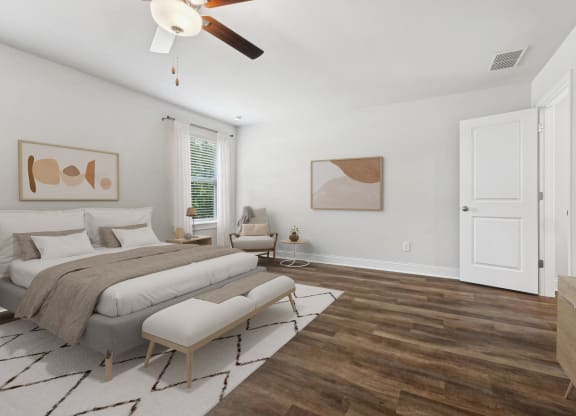 a bedroom with a large bed and a ceiling fan