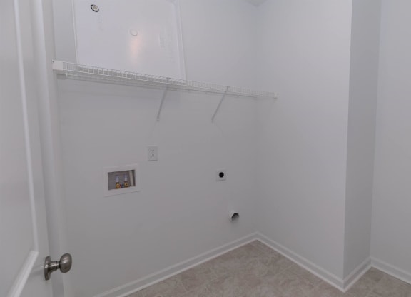 a bedroom with a closet and a wall with a shelf and a door