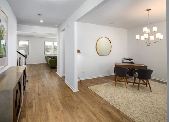 a dining room and living room with a table and chairs