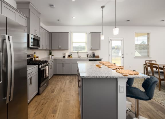 a kitchen with stainless steel appliances and a marble counter top