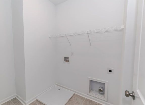 a bathroom with white walls and a shower and a toilet