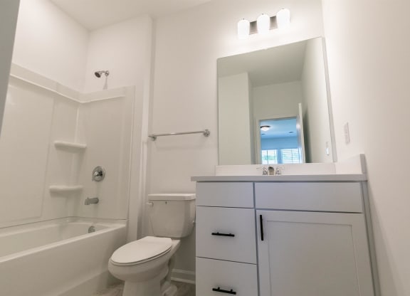 a bathroom with a sink toilet and a mirror