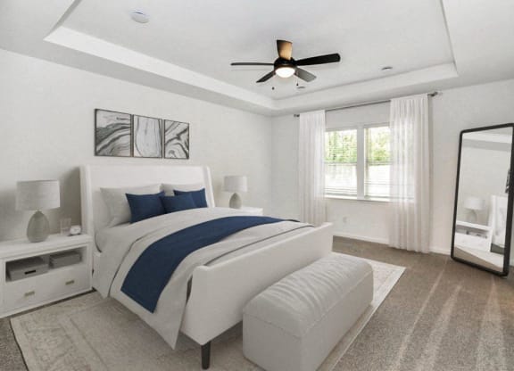 a white and blue bedroom with a bed and a ceiling fan