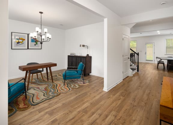 a living room with a dining room and a staircase