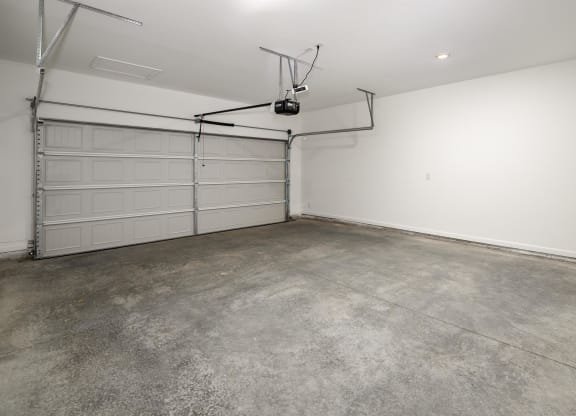 the interior of a garage with a white wall and a garage door