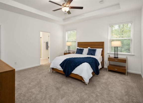 a bedroom with a bed and a ceiling fan
