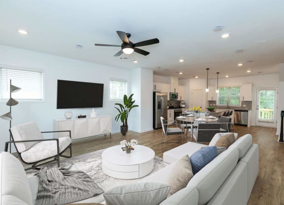 a living room with a couch and a ceiling fan