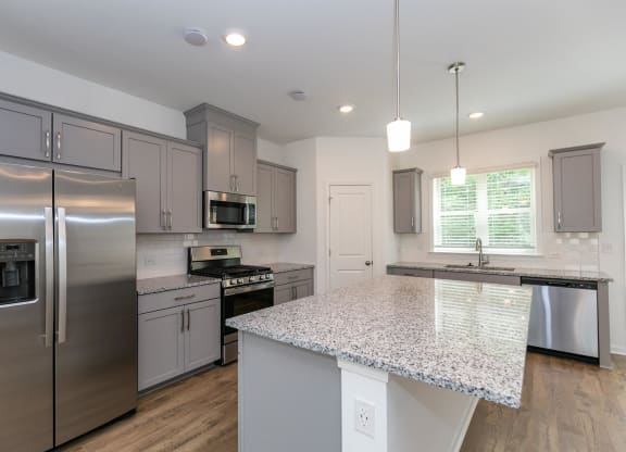 a kitchen with stainless steel appliances and a granite counter top