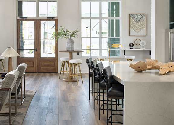 Inviting clubhouse space bathed in natural light with modern seating throughout.