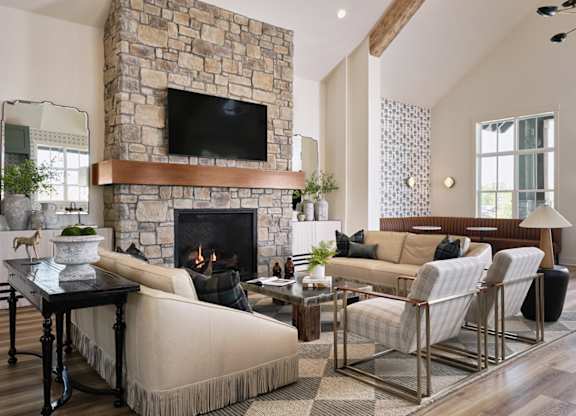 Clubhouse living room with ample seating, fireplace and TV.
