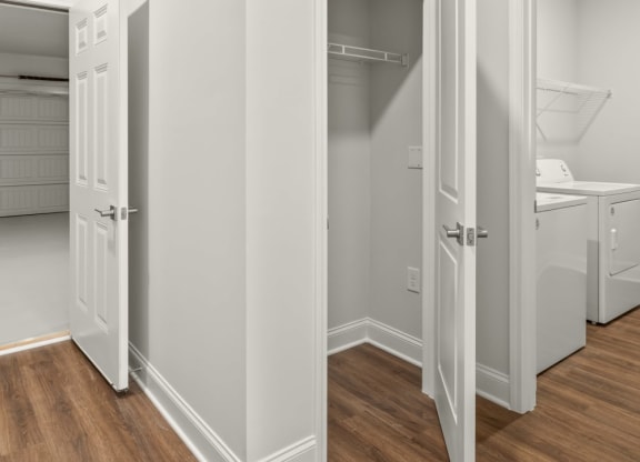 a bedroom with a closet and a door to a bathroom
