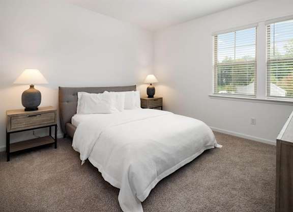Secondary bedroom with queen size bed and large window letting in a ton of natural light.