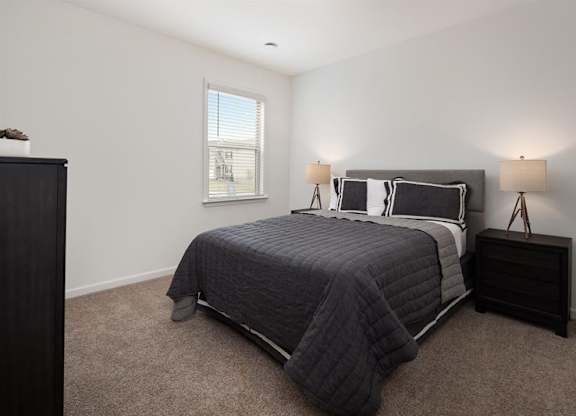 The third bedroom with queen size bed and large window letting in a ton of natural light.