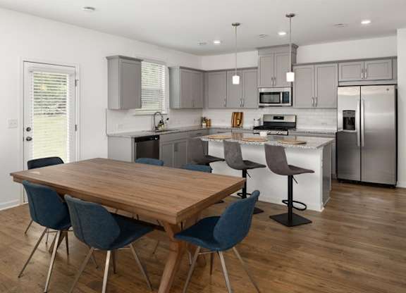 Spacious kitchen with an island, ample storage, and stainless steel appliances.