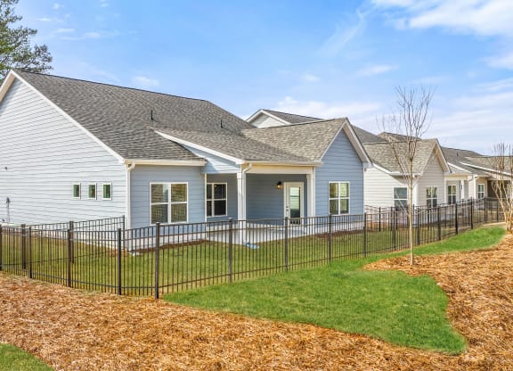 a white house with a black fence in front of it