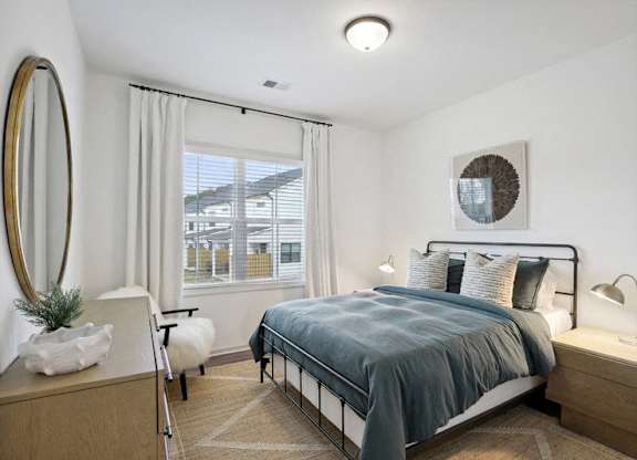 Secondary bedroom with queen size bed and large window letting in a ton of natural light.