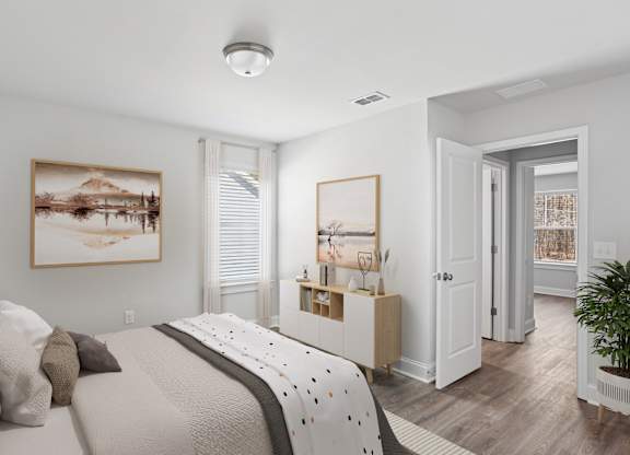 Secondary bedroom with queen bed, large sunlit window.