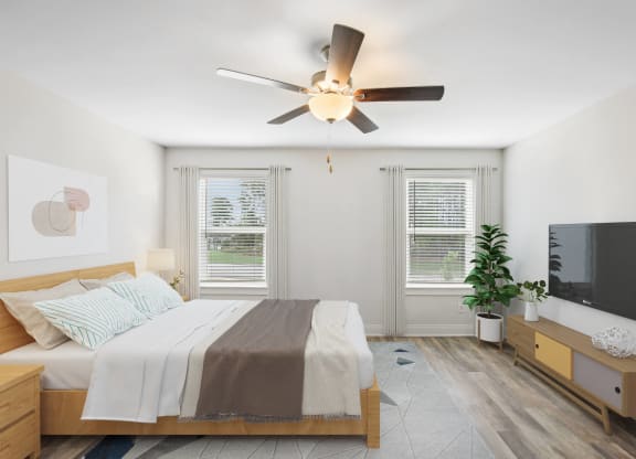 a bedroom with a bed and a ceiling fan