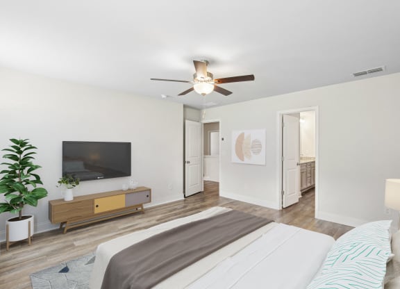 a bedroom with a large bed and a ceiling fan