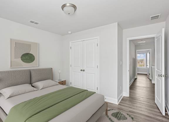 Secondary bedroom with queen size bed and large window letting in a ton of natural light.