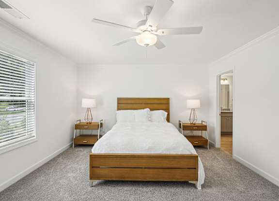 a bedroom with a large bed and a ceiling fan