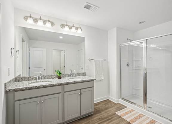 a bathroom with a large mirror and a shower