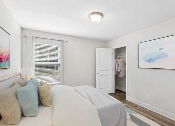 a bedroom with a bed and a door to a closet
