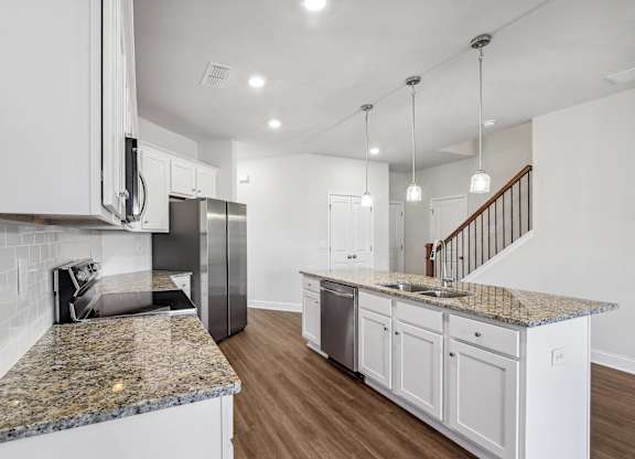 A view of the spacious kitchen and stainless steel appliances