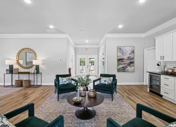 a living room with chairs and a table