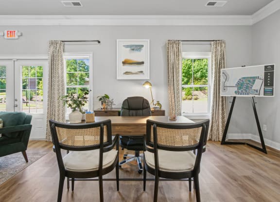 a dining room with a table and chairs and a easel in a room with