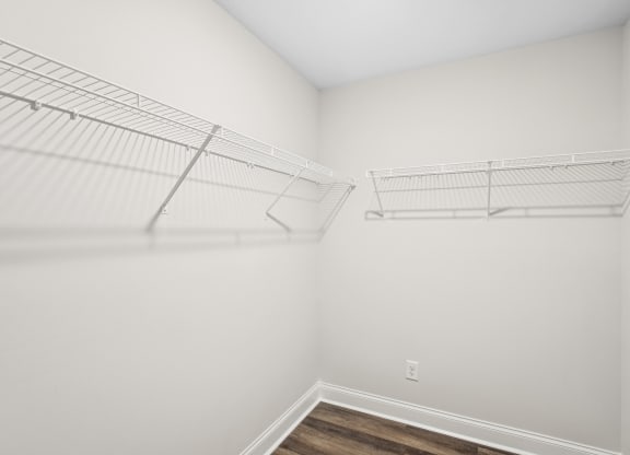 an empty closet in a room with white walls and wood flooring